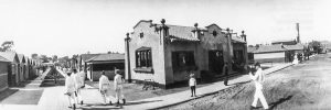 A young Skip (in short pants) stands in front of the Cottage City office, 1912