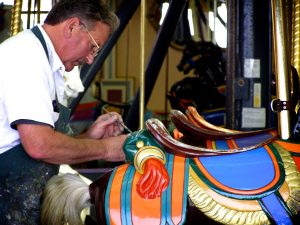 Boardwalk painter, Jimmy Raun-Byberg touching up the horses