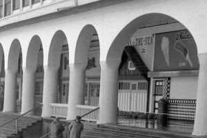 The pie shop (on the left behind the columns) and the black-and-white tiled ice cream store (on the right), 1958