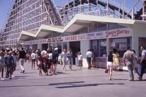 Boardwalk concession building in front of the Giant Dipper, 1963. The Danish Pastry concession is on the far right