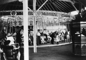 Mothers, children, and ride attendant on the Looff Carousel in 1911