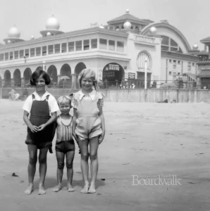 children standing in front of Boardwalk black and white