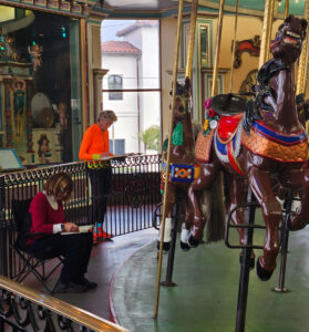 Local artists studying the Looff Carousel, 2025