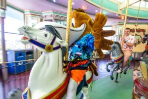 Splash the Pelican going for a spin on the Looff Carousel.