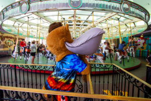 Splash patiently waiting in line for a ride on the Looff Carousel.