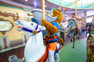 Splash and Nicholas riding the Carousel.