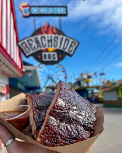 BBQ ribs from Beachside BBQ with the restaurant sign in the background